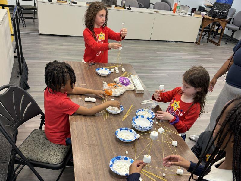 Children work with marshmallow craft at Take Your Child to Work Day 2024.